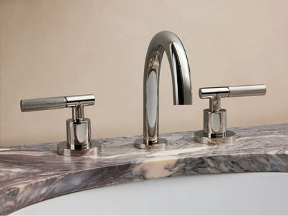 Crewe Knurled Faucet in polished nickel on a marble countertop with two knurled handles and a curved spout.
