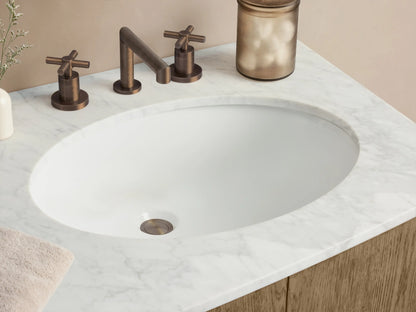 Danny Double Vanity: Light oak double vanity with rounded ends, white marble top, two oval sinks, 2 doors, 3 drawers, dark handles.