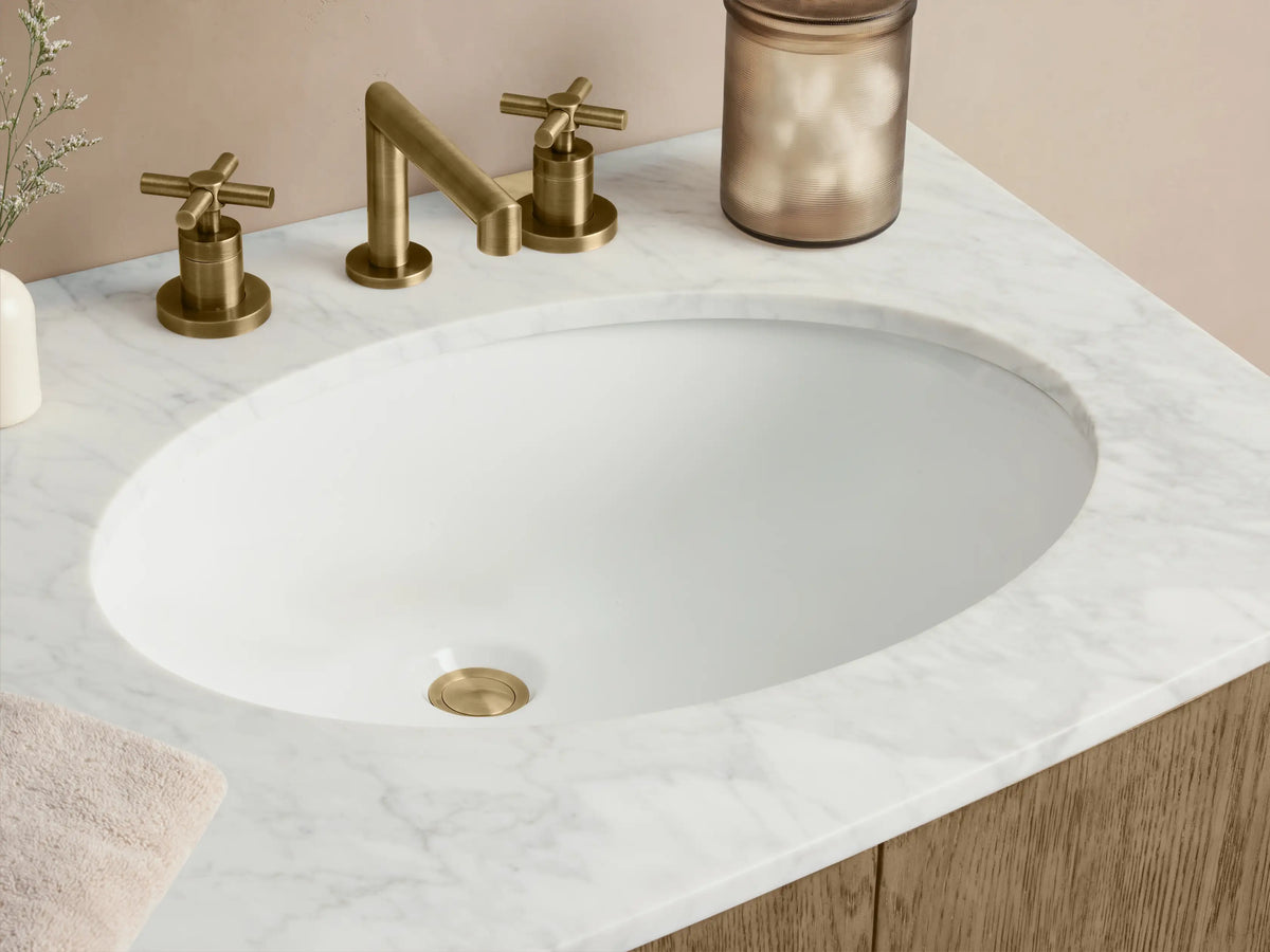 Danny Double Vanity featuring light oak wood with three central drawers, two side cabinets, and oval sinks on a stone top.