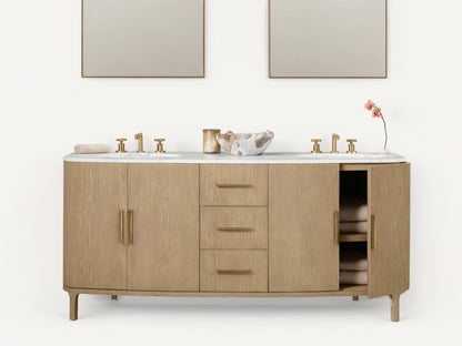 Danny Double Vanity made of oak wood with brass hardware, two sinks, and a marble top. Features multiple drawers and open shelves.