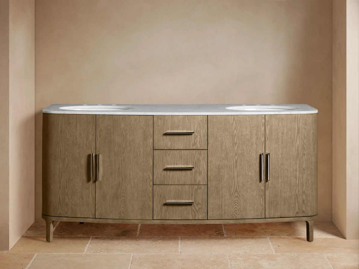 Danny Double Vanity in light oak with two sinks, Carrara marble top, three central drawers, and side cabinets.