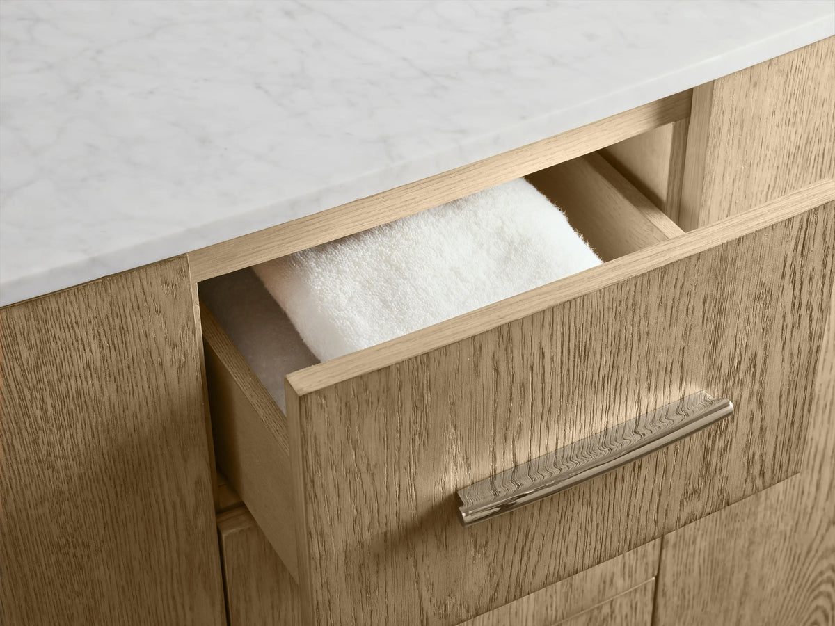 Danny Double Vanity featuring oak wood finish, open door showing shelf with towels, silver handles, and drawers on the side.