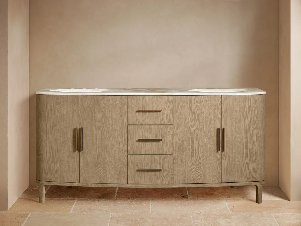 Danny Double Vanity: light wood with visible grain, white marble top, dual sinks, dark faucets. Left cabinet open showing towels, 3 drawers, 2 doors.