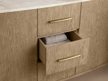Oak wood vanity detail showing open cabinet with single door, curved edge, soft-close hinge, shelf, and folded towels inside.