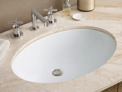Danny Double Vanity featuring an oak wood structure with curved edges, dual ceramic sinks, silver hardware, and marble top, set against a beige wall.