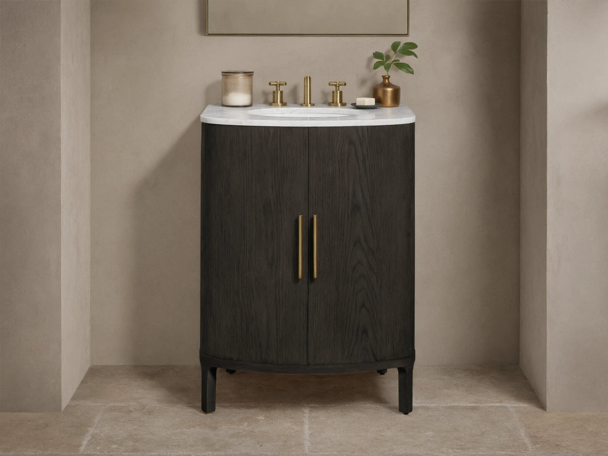 Danny Powder Vanity: dark oak, curved cabinet, white marble top, oval sink, brass faucet, two vertical brass door handles.