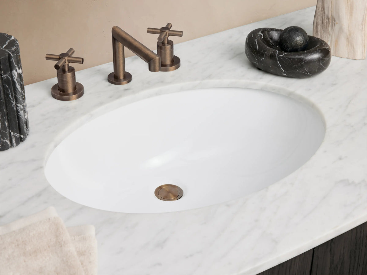 Danny Wide Single Vanity: Dark oak wood vanity with white marble top, oval sink, 2 doors, and 6 curved drawers with bronze pulls.