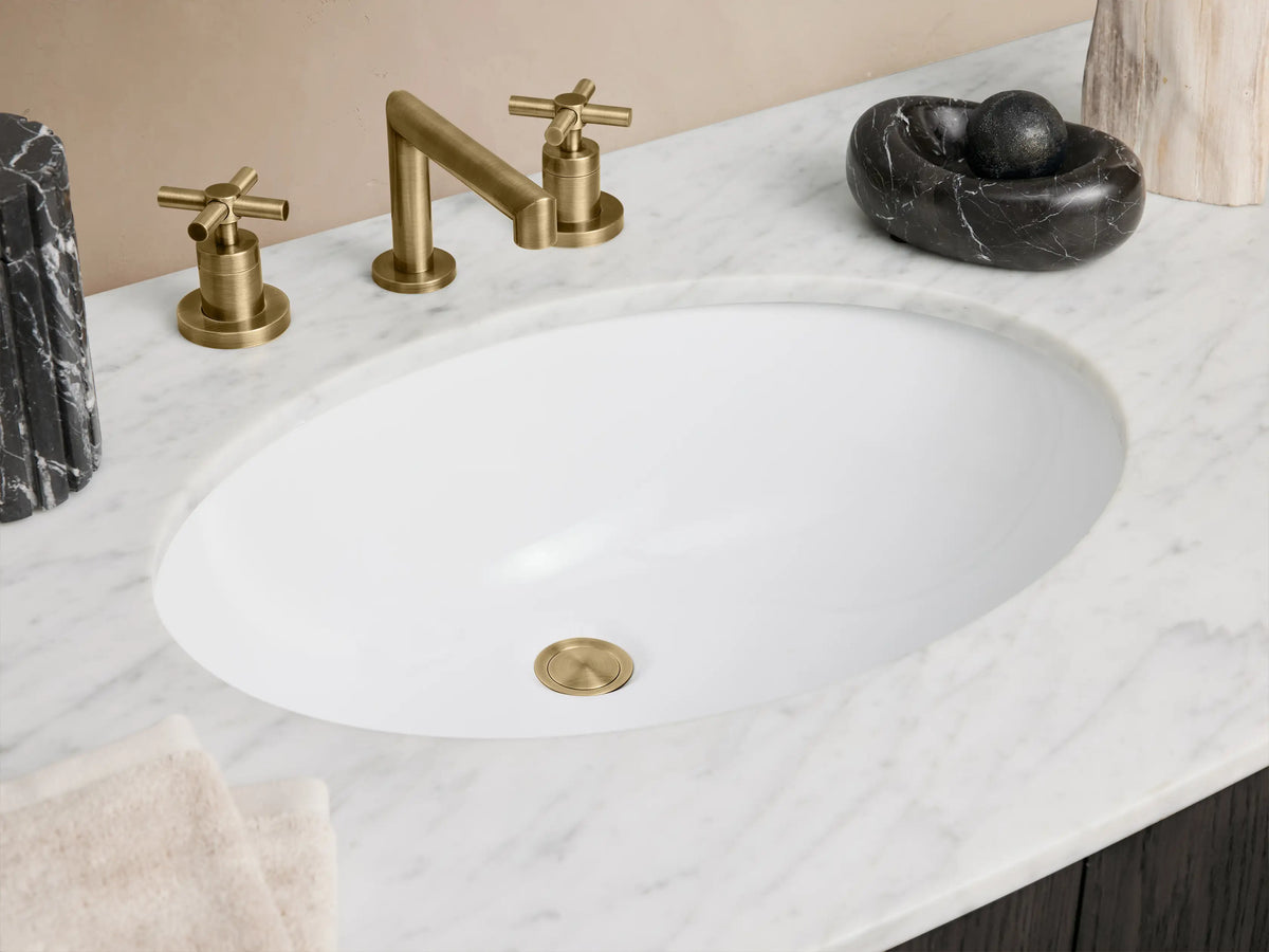 Dark oak Danny Wide Single Vanity with white Carrara marble top, oval sink, and brass hardware on 2 doors & 6 drawers.