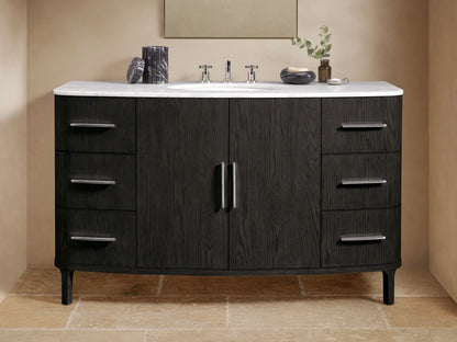Danny Wide Single Vanity: Dark oak wood with prominent grain, white Carrara marble top, oval sink, polished nickel handles.