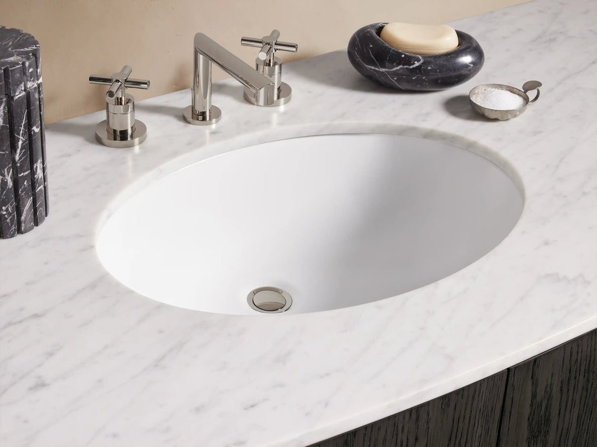Danny Wide Single Vanity in dark oak with white marble top, oval sink, and polished nickel hardware on curved drawers & doors.