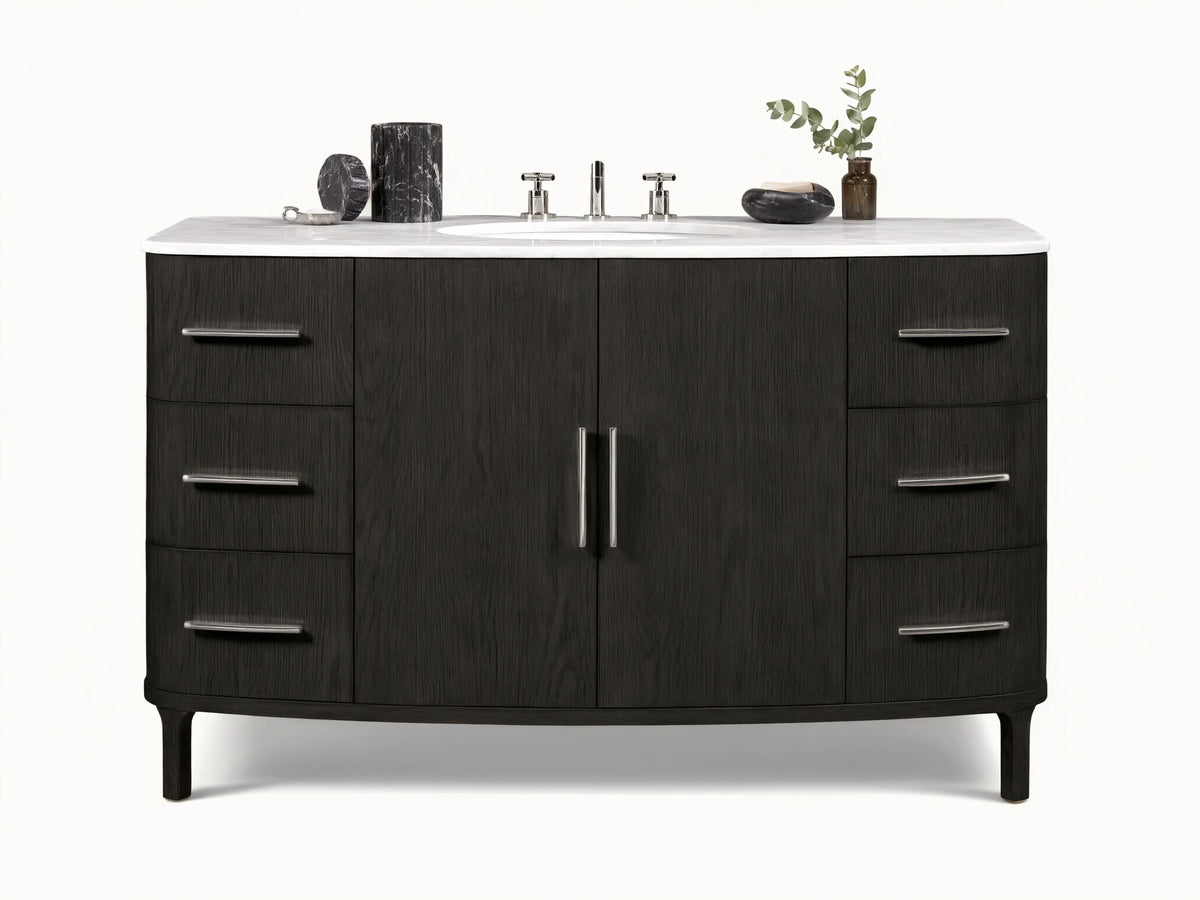 Danny Wide Single Vanity: Dark oak wood with prominent grain, white Carrara marble top, oval sink, polished nickel handles.