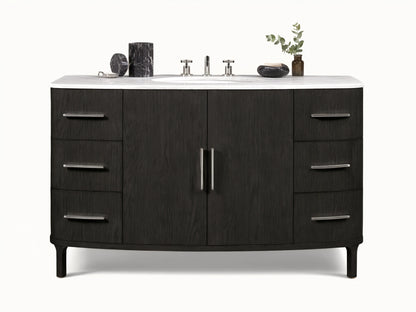 Danny Wide Single Vanity: Dark oak wood with prominent grain, white Carrara marble top, oval sink, polished nickel handles.