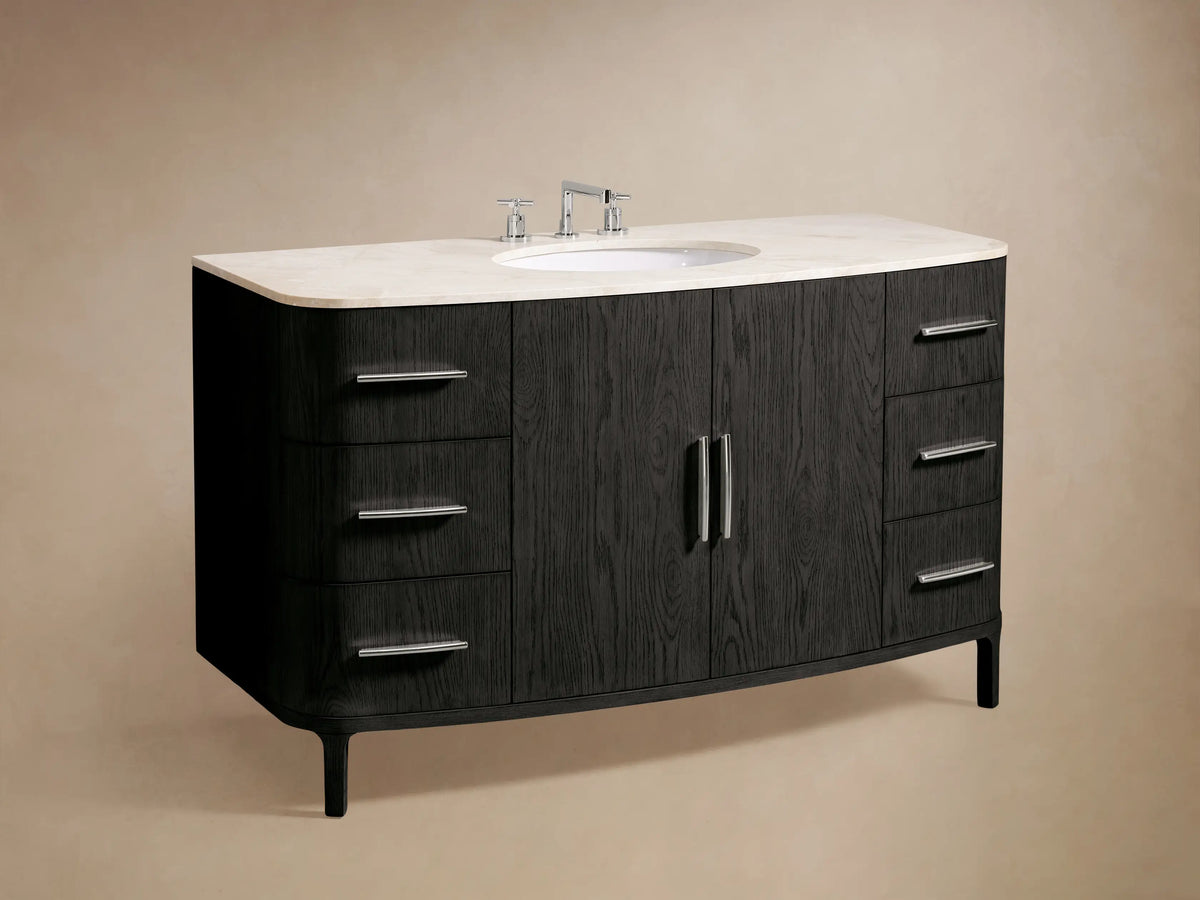 Danny Wide Single Vanity close-up. Dark oak wood cabinet with light marble top and polished nickel handle. Bottom drawer slightly open with towel.