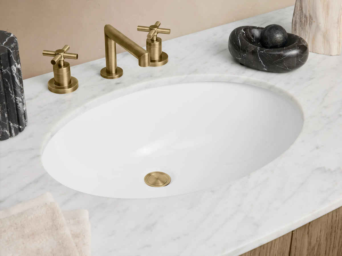 Danny Single Wide Vanity in oak wood with brass hardware, curved design. Features marble top, undermount sink, and dual doors.