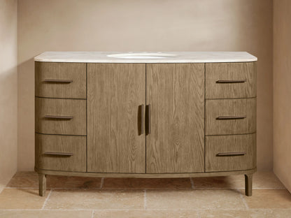 Light brown oak wood Danny Wide Single Vanity with a white marble top, oval sink, and dark bronze hardware. Six drawers, two central doors.