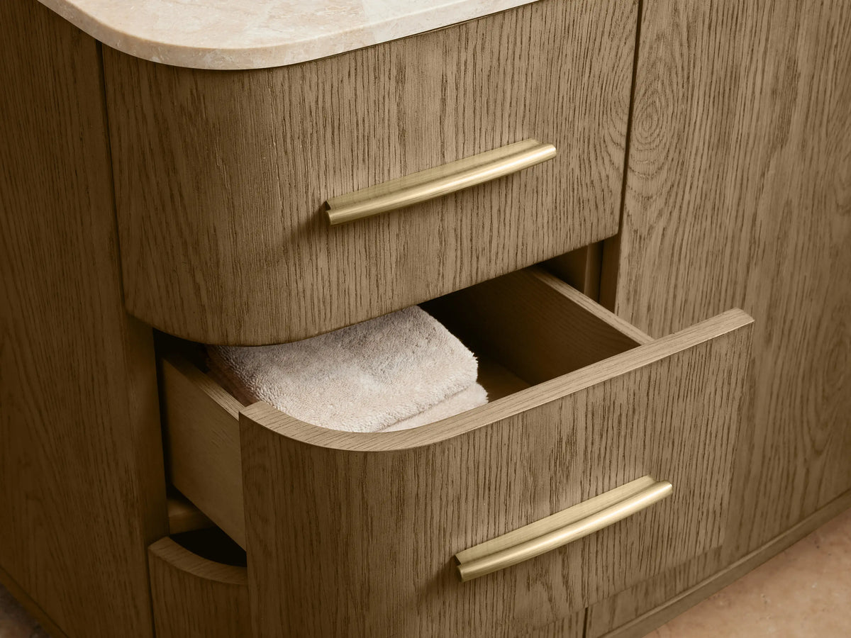Danny Single Wide Vanity made of oak wood with a marble top. Features brass hardware, six drawers, and two central doors.