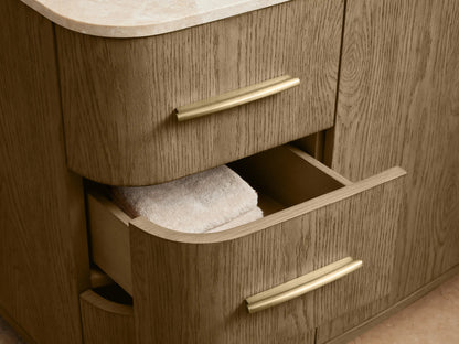 Danny Single Wide Vanity made of oak wood with a marble top. Features brass hardware, six drawers, and two central doors.