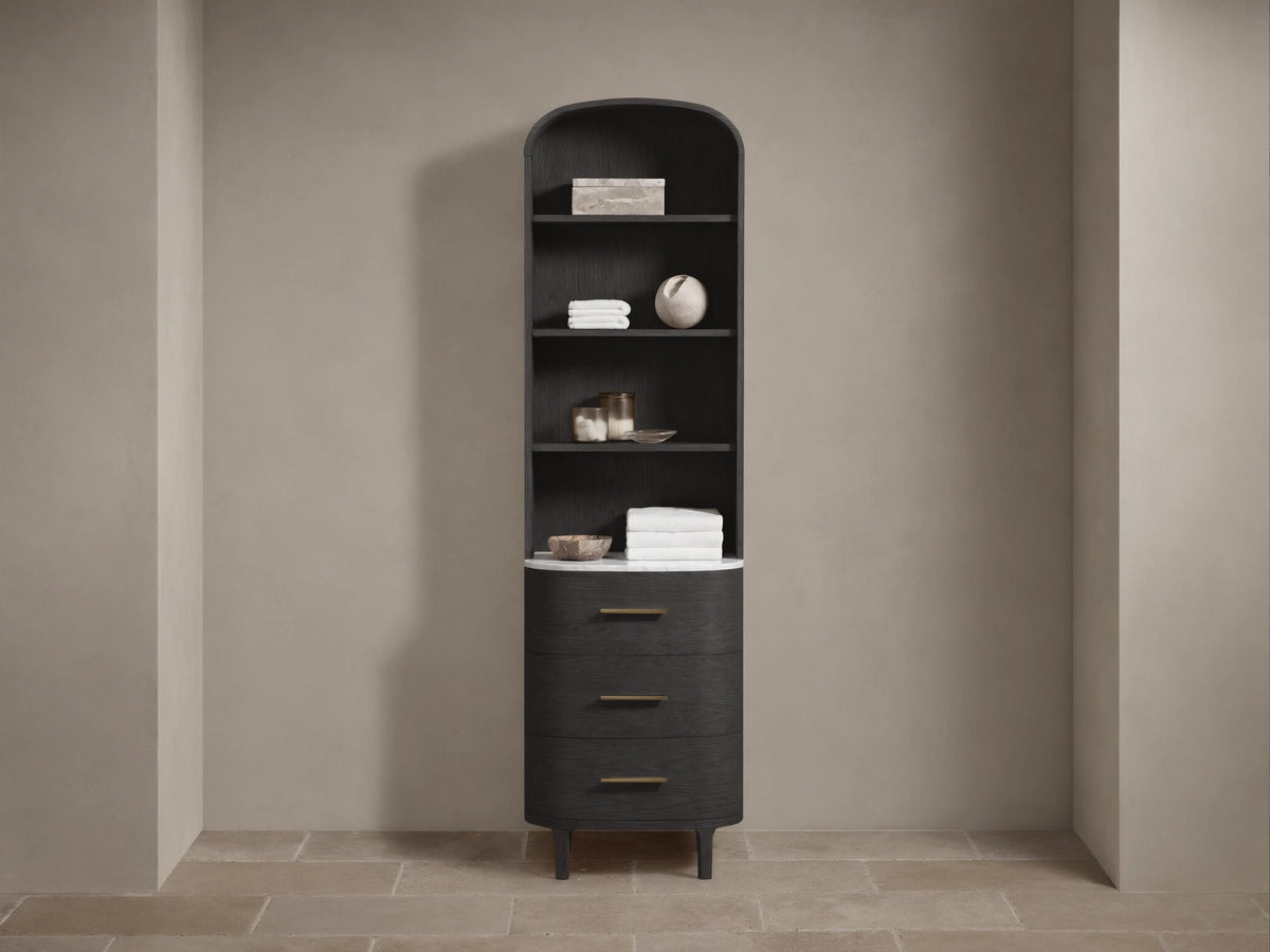 Tall, dark wood Danny Bath Cabinet with arched top, open shelves, white marble counter, and 3 curved drawers with brass pulls.