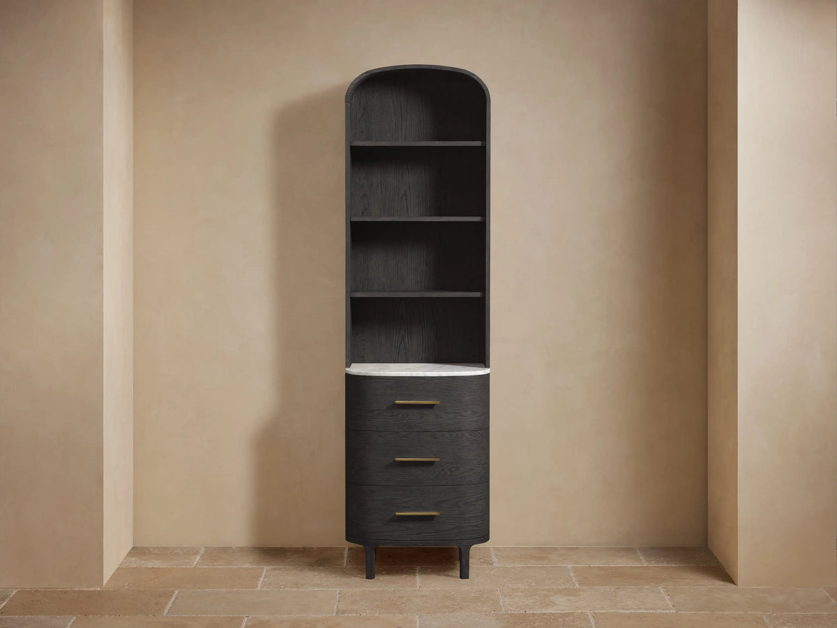 Tall, dark wood Danny Bath Cabinet with arched top, open shelves, white marble counter, and 3 curved drawers with brass pulls.
