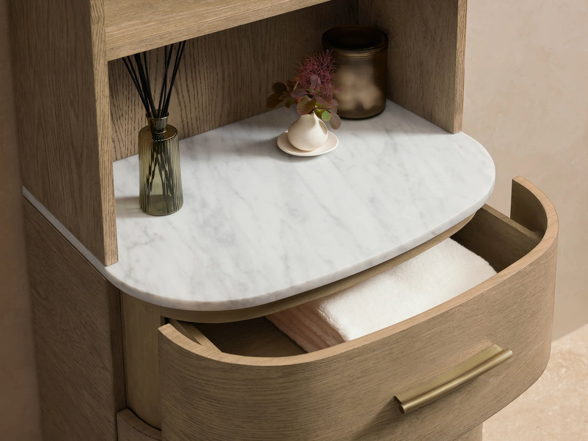 Danny Etagere, tall oak and plywood unit with four shelves and three drawers. Features a stone top, set against a beige wall.
