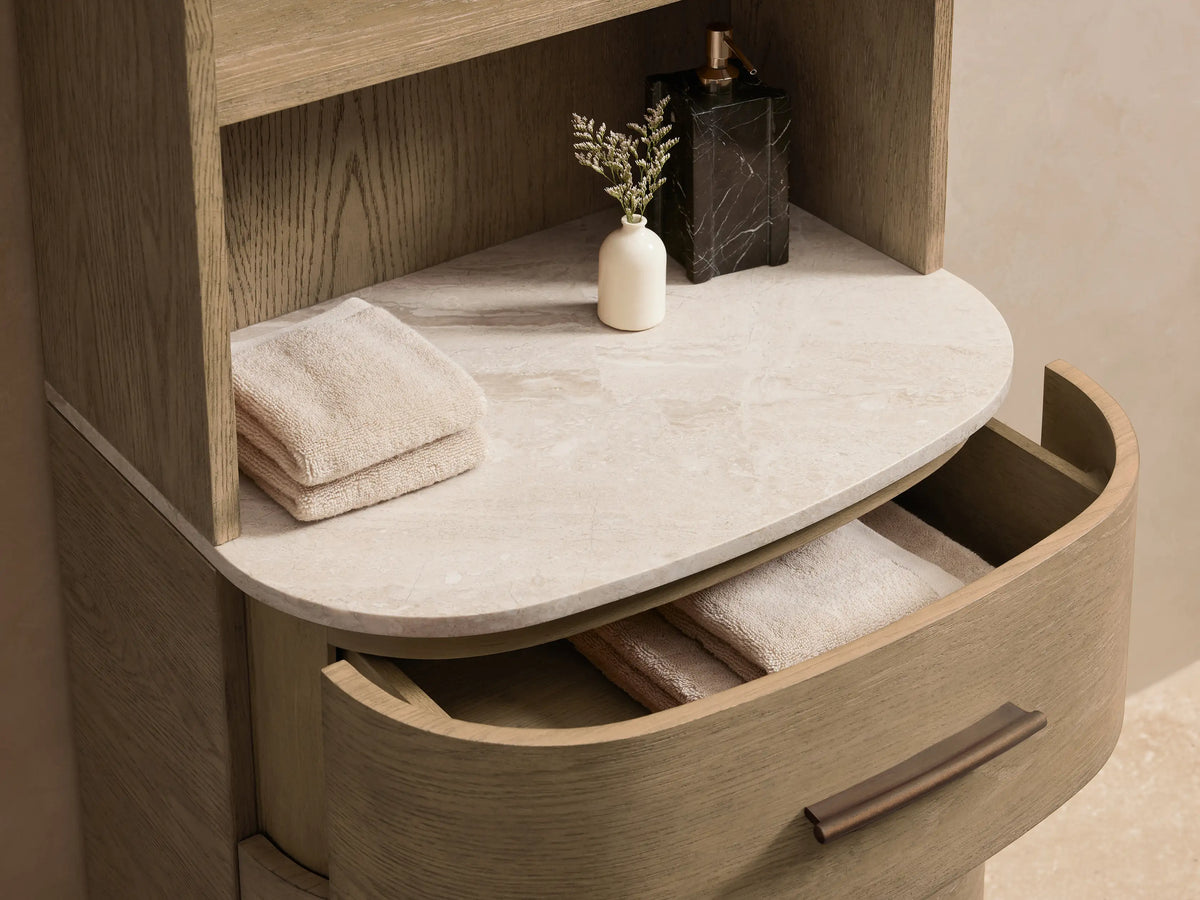 Light oak Danny Bath Cabinet with an arched top, 4 open shelves, a white stone top, and 3 curved drawers with dark pulls.