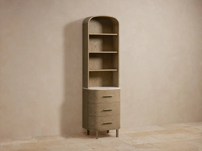 Danny Etagere made of oak with a curved top design, featuring three drawers and open shelves, set against a beige wall.