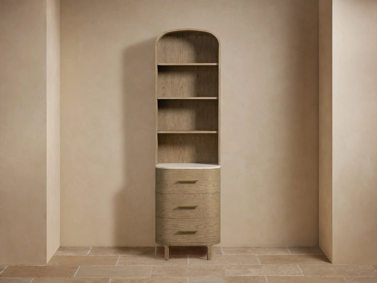 Danny Etagere with oak wood shelves, a Carrara marble top, small vase, and a stack of towels on the shelf.