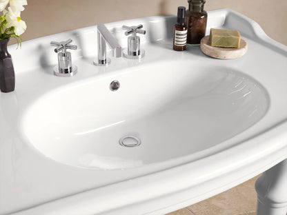White Eloise Single Washstand, elegant fire clay with integrated sink, faucet holes, and four graceful legs, against a beige wall.
