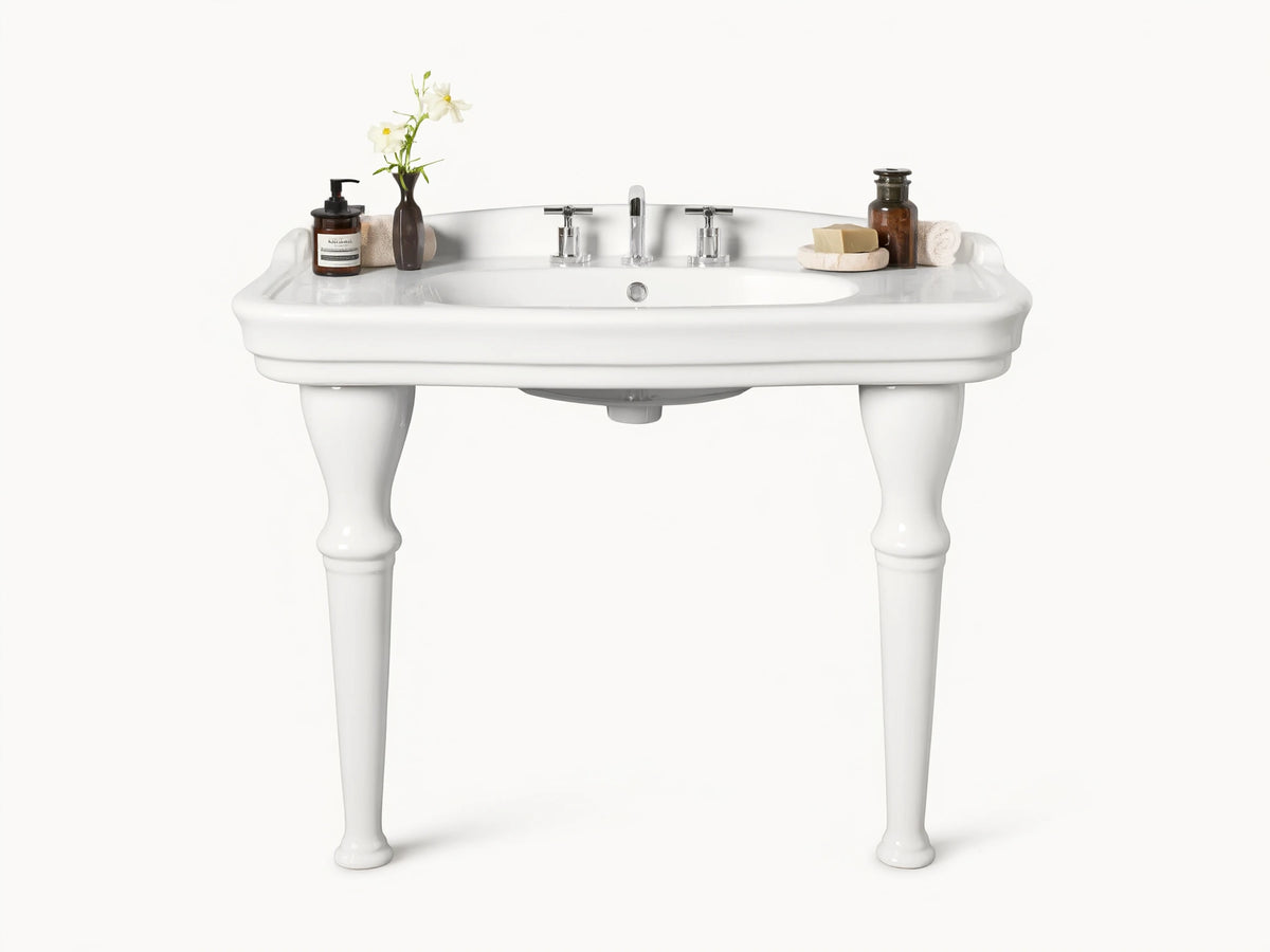 Front view of white ceramic Eloise Single Washstand with integrated sink, sculpted legs, and chrome faucet, in a beige bathroom.