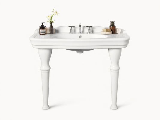 Front view of white ceramic Eloise Single Washstand with integrated sink, sculpted legs, and chrome faucet, in a beige bathroom.