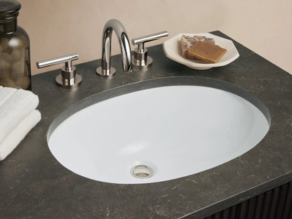 Finnley Double Vanity: Dark fluted cabinet, dark gray bluestone top, two white oval sinks, polished nickel hardware, shown against a light wall.