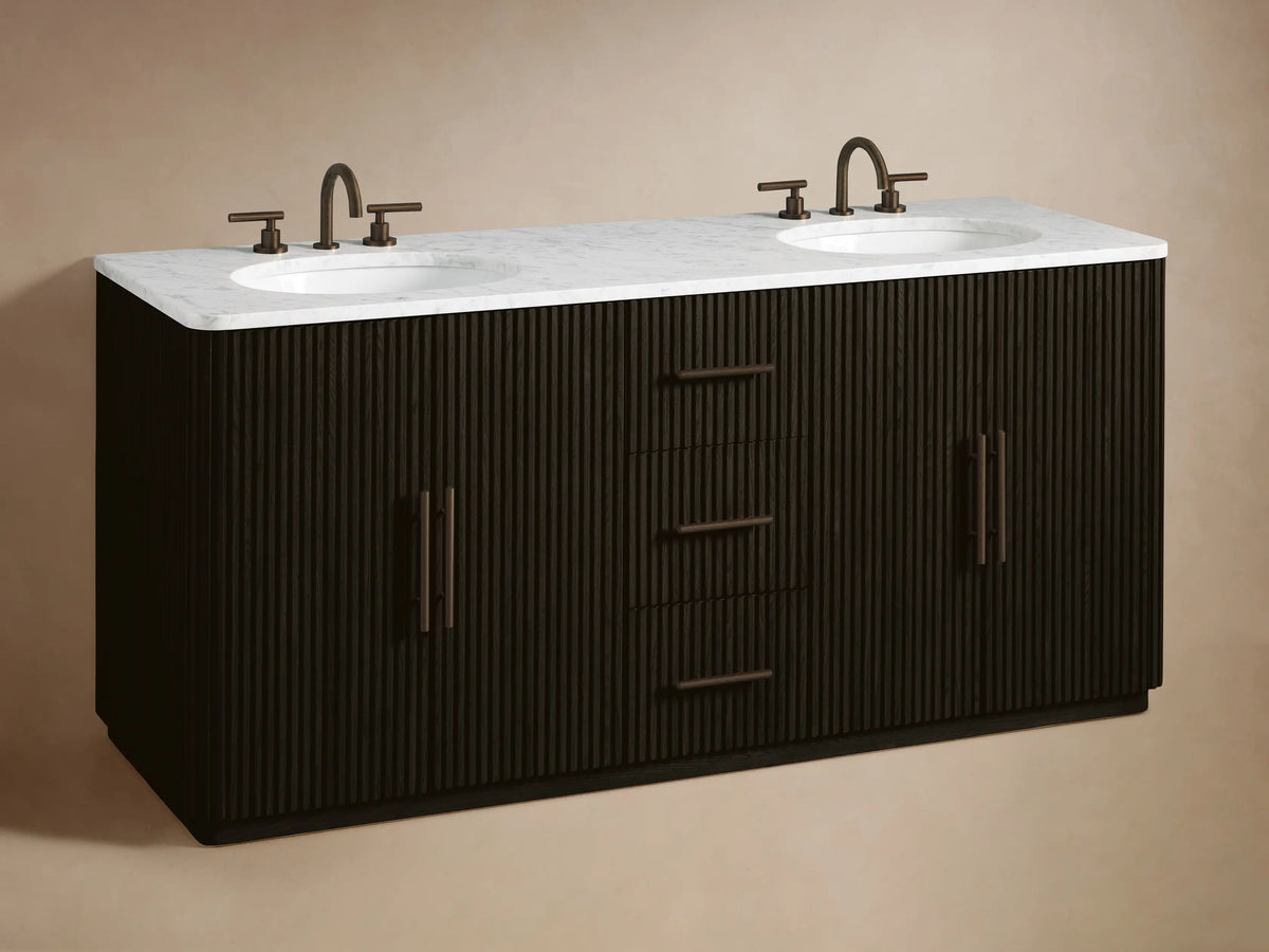 Close-up of Finnley Double Vanity's dark ribbed wood drawer, partially open, revealing folded light towels inside. Bronze hardware.