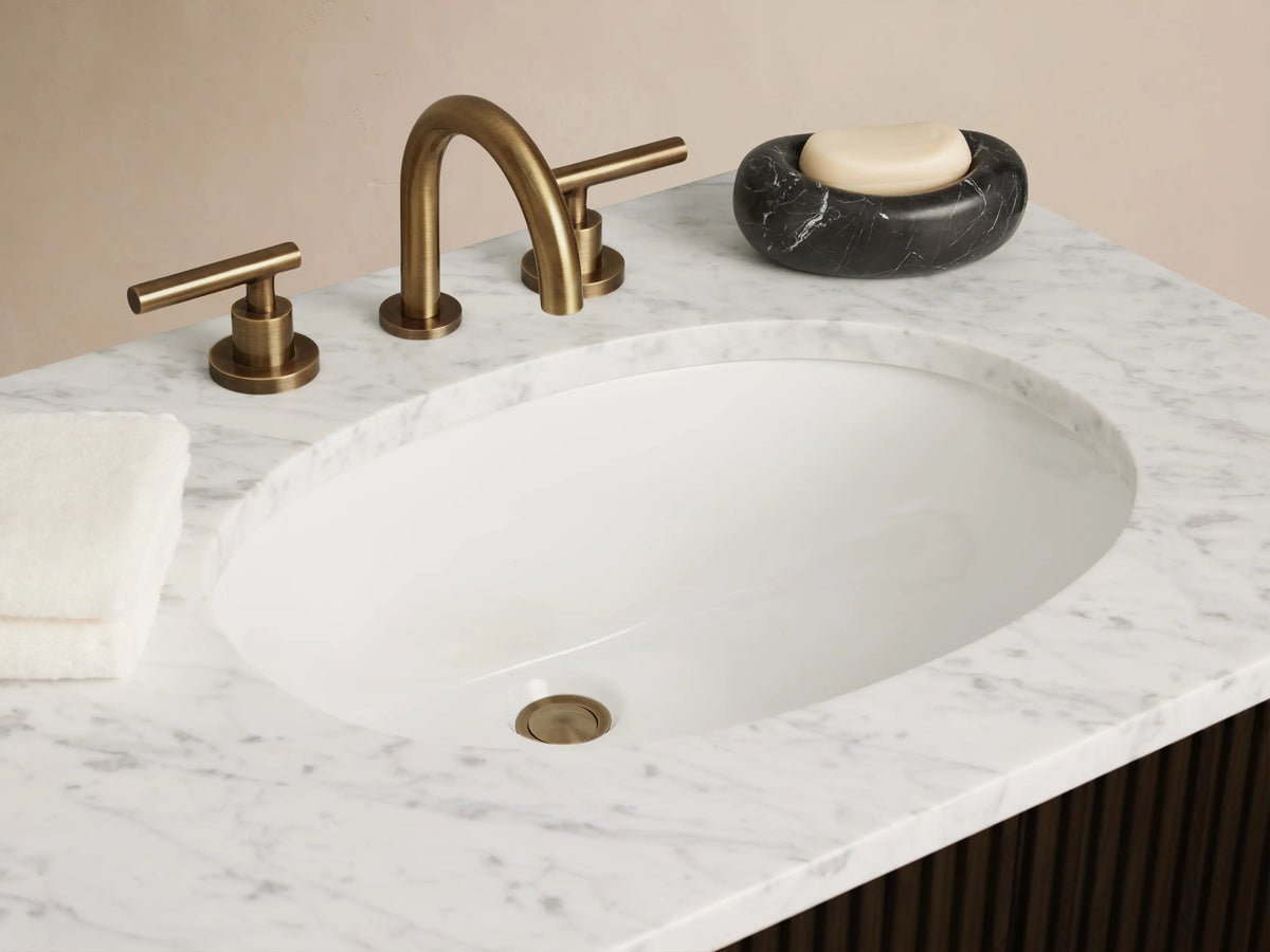 Front view of a Finnley Double Vanity in dark brown wood with reeded texture, white marble countertop, two oval sinks, and brass hardware.