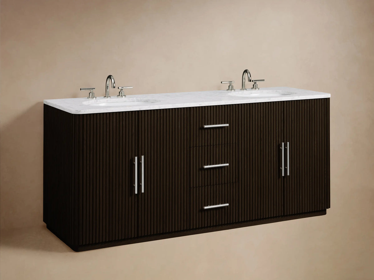 Close-up of Finnley Double Vanity with dark brown fluted wood, white marble top, and open drawer holding white towels and a bottle.