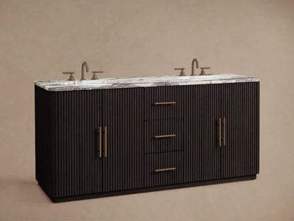 Finnley Double Vanity: dark ribbed wood base, white marble top with purple veins, 2 bronze faucets, 1 open cabinet with towels.
