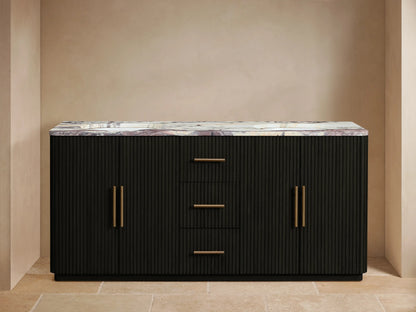 Black fluted Finnley Double Vanity with veined marble top, two sinks, gold faucets, and open left door revealing towels.