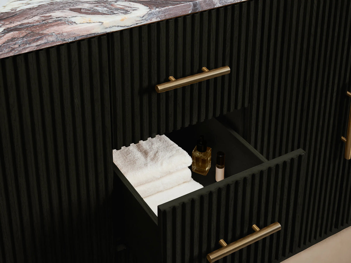 Close-up of Finnley Double Vanity's black ribbed door, slightly open, with a gold handle, revealing an interior shelf with white towels.