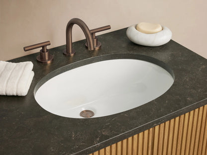 Finnley Double Vanity: light oak slatted cabinet, dark bluestone countertop with two oval white sinks, and dark bronze hardware.