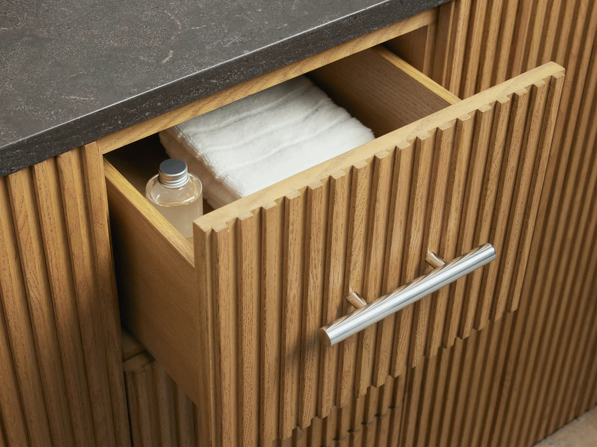 The image shows the inside of the Finnley Double Vanity oak wood cabinet, open with shelves holding folded towels and toiletries.