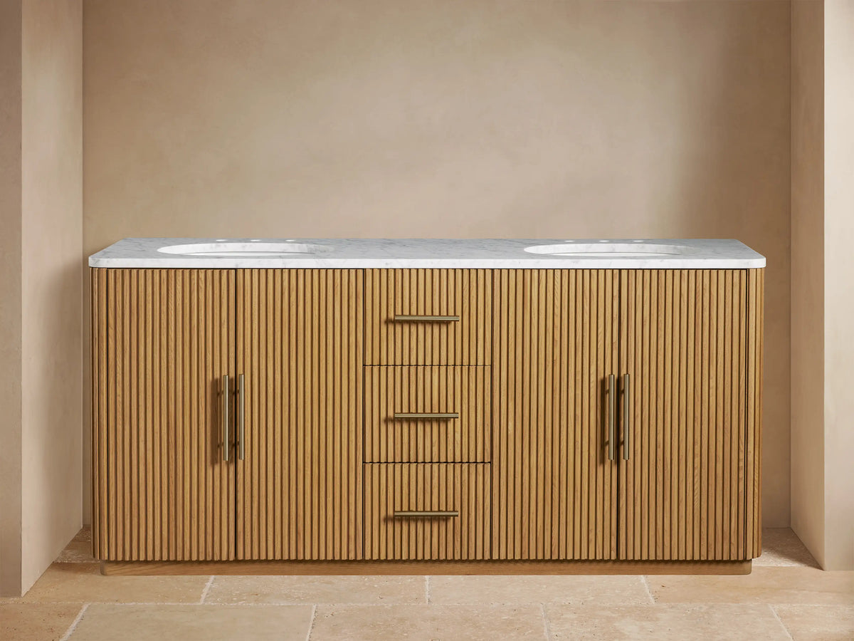 Finnley Double Vanity with oak wood finish, fluted design, two white sinks, three central drawers, and open door showing shelves.