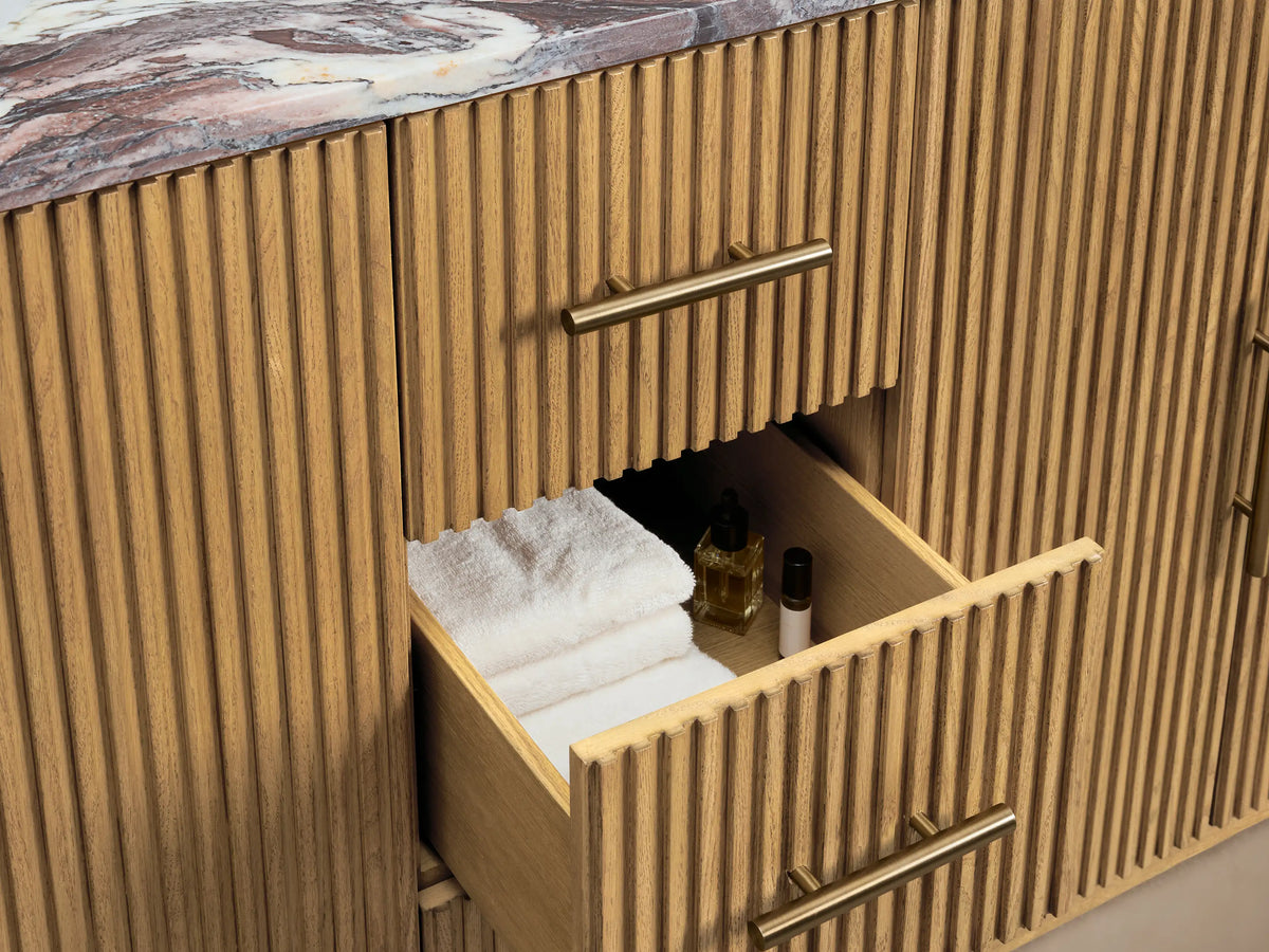 Close-up of Finnley Double Vanity's open ribbed oak door, brass handle, showing inside with shelves and white towels.