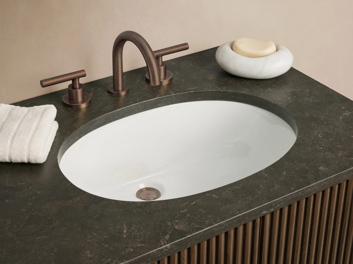 Finnley Double Vanity: Dark oak slatted cabinet with bluestone top, two white oval sinks, dark bronze faucets & hardware.