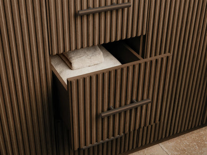 Finnley Double Vanity. Open dark fluted oak cabinet with bronze handle revealing a sponge in a white bowl and stacked white towels.