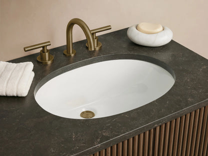 Finnley Double Vanity: Dark oak, ribbed cabinet with gray stone top, two white oval sinks, 2 doors, 3 drawers, antique brass pulls.