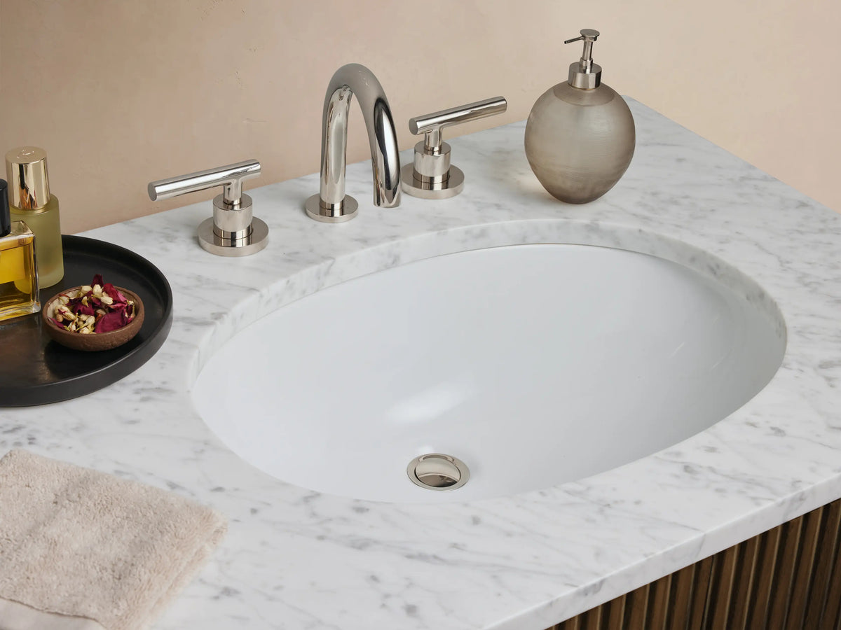 Dark wood Finnley Double Vanity with vertical fluting, white Carrara marble top, two sinks, 2 cabinets, 3 drawers with polished nickel pulls.