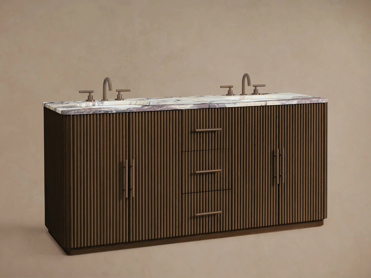 Finnley Double Vanity: Dark fluted wood base, light marble top with purple veining, two dark faucets, left door open revealing towels.