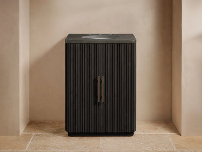 Finnley Powder Vanity: Dark brown fluted cabinet with bronze handles, gray stone top, white oval sink, widespread bronze faucet.