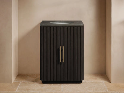 Finnley Powder Vanity with dark wood slatted design, marble top, and oval sink. Features antique brass hardware on a single door.