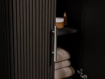 Finnley Powder Vanity with vertical ribbed oak wood design, dark finish, stone top with oval sink, and silver hardware.
