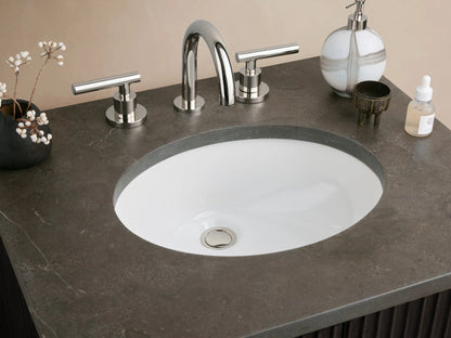 Finnley Powder Vanity with black ribbed oak door, silver handle, and dark stone top, set against a beige wall.